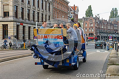 People riding excursion bicycle in Amsterdam, the Netherlands Editorial Stock Photo