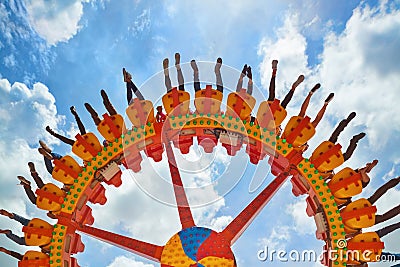 People riding with fun on extreme attraction in amusement park Stock Photo