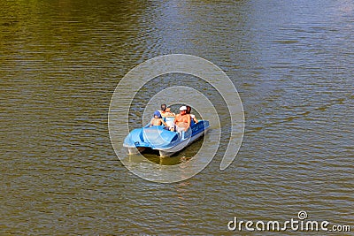 People riding pedalo boat on Khorol river in Myrhorod, Ukraine Editorial Stock Photo