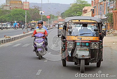 People are riding in vehicles by street in Jaipur, India Editorial Stock Photo