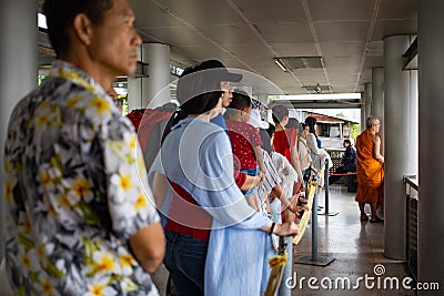 People in row waiting for boat on the pier Editorial Stock Photo