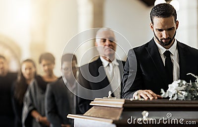 People, sad and funeral coffin, death and grief in church during ceremony or service, depression or floral. Support Stock Photo