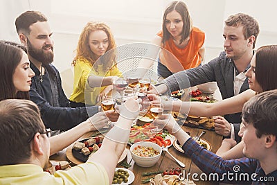 People say cheers clink glasses at festive table dinner party Stock Photo