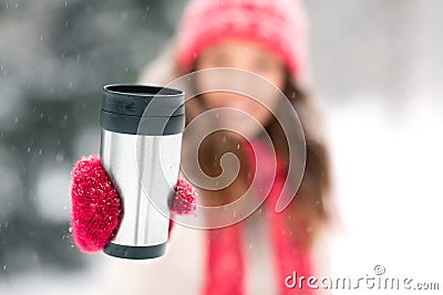 Hand holding tumbler or thermo cup in winter Stock Photo