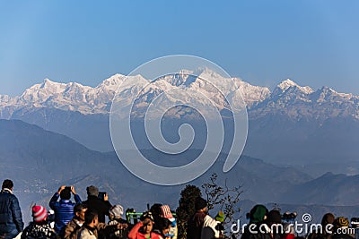 People are seeing the first light of new year`s day at dawn with mountain villages and Kangchenjunga mountain in winter. Editorial Stock Photo