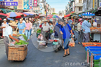 People selling and buying food in a traditional fruit and vegetable market of Taiwan Editorial Stock Photo