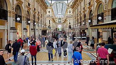 People shopping in famous Vittorio Emanuele Galleria, luxury boutiques and cafes Editorial Stock Photo