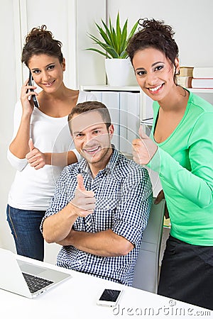 People showing thumbs up in office Stock Photo
