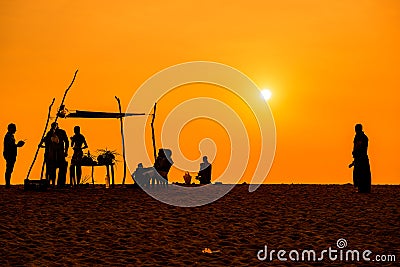 People silhoettes at sunset on a beach Editorial Stock Photo