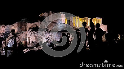 People silhouettes in the foreground, with Acropolis night view at the background Editorial Stock Photo