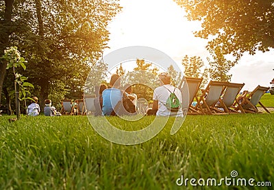 People sit in the park at the summer cinema Editorial Stock Photo