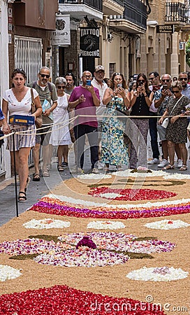 People during Sitges Corpus Christi at a flower carpet in Sitges, Spain Editorial Stock Photo