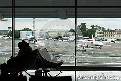 People sitting in the airport lounge waiting for boarding on a f Editorial Stock Photo