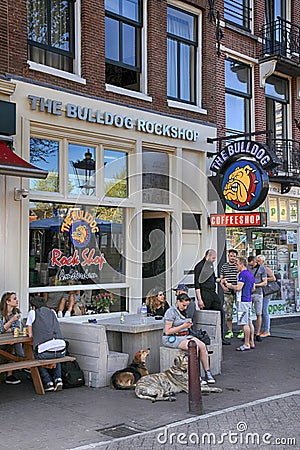 People sitting at Bulldog coffeeshop on the street in Amsterdam Editorial Stock Photo