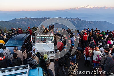 People are sitting on the car with crowd for seeing the first light of new year`s day at dawn with mountain villages. Editorial Stock Photo