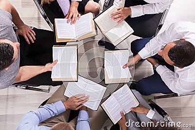 People Sitting In A Circle Reading Bible Stock Photo