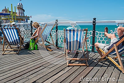 People sitting in deck chair s on the pier Editorial Stock Photo