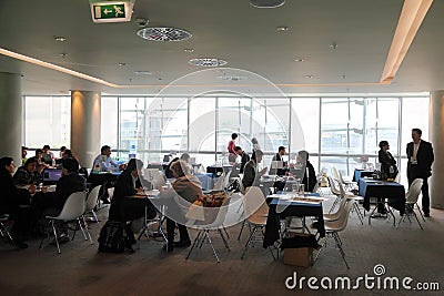 People sitting at discussion tables Editorial Stock Photo