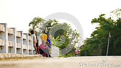 people sitting on the road side outdoor image Editorial Stock Photo