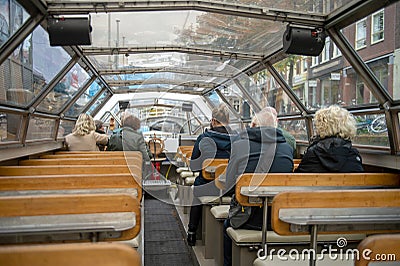 People are sitting in a sightseeing boat. canal boat cruise in autumn Editorial Stock Photo