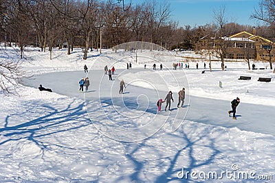 People skating at Lafontaine Park natural ice rink Editorial Stock Photo