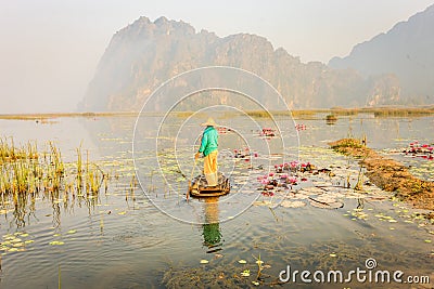 People with small boat on Van Long pond, Ninh Binh province, Vietnam Stock Photo