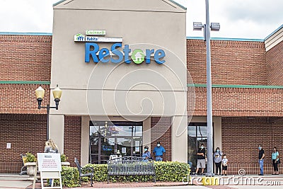 People social distance in line outside at the ReStore Editorial Stock Photo