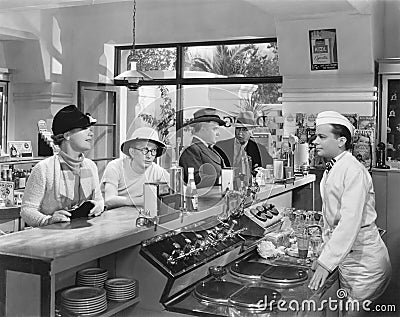 People at a soda fountain Stock Photo