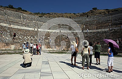 People stand at the base of the Roman theatre ruins at the ancient site of Ephesus in Turkey. Editorial Stock Photo