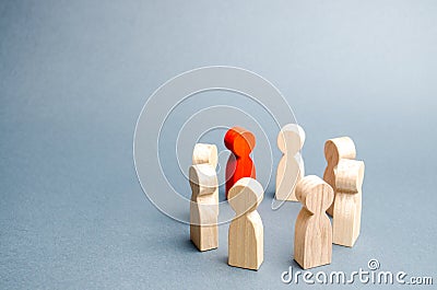 People stand in a circle on a gray background. Communication. Business team, teamwork, team spirit. Wooden figures of people. A Stock Photo