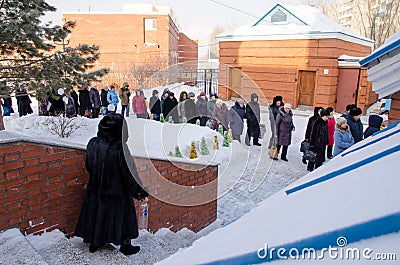 People stand in line in the cathedral for blessed water Editorial Stock Photo