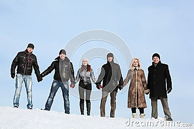 People stand on snow and to hold on to hands Stock Photo