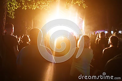 People stand at a street performance late at night Editorial Stock Photo