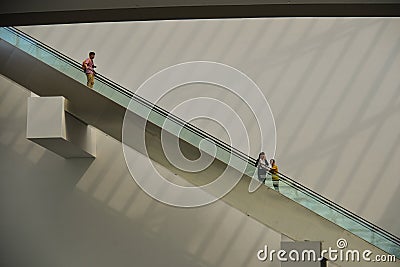 People standing on escalator in shopping mall Editorial Stock Photo