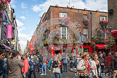 People in the street in front of the famous Temple Bar, in Dublin Ireland Editorial Stock Photo