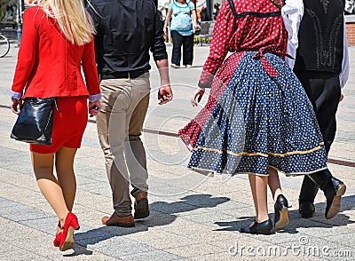 People on the street in regular and traditional clothing Stock Photo