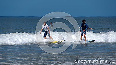 People surfing in Tamarindo Editorial Stock Photo