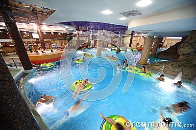 People swim on inflatable circles in pool Editorial Stock Photo