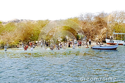 People swim in the Nile river. Aswan, Egypt Editorial Stock Photo