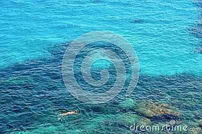 People swimm and snorkeling inside paradise clear torquoise blue water in Favignana island, Bue Marino Beach, Sicily Sout Stock Photo