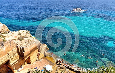 People swimm and snorkeling inside paradise clear torquoise blue water in Favignana island, Bue Marino Beach, Sicily Sout Editorial Stock Photo