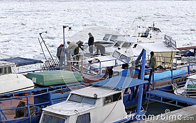 People take out trapped boat from the frozen Danube river Editorial Stock Photo