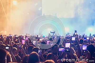 People taking photographs with touch smart phone during a music entertainment public concert Editorial Stock Photo