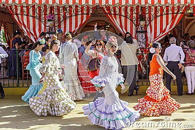 People taking a walk and enjoying at the Seville`s April Fair. Editorial Stock Photo