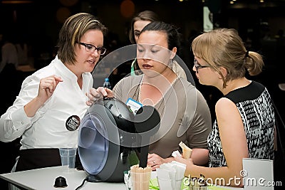 People tasting coffee at the Nescafe Dolce Gusto product launch event in Johannesburg, South Africa Editorial Stock Photo