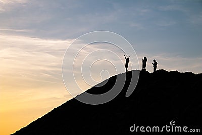 People at the top rejoice at sunrise Stock Photo