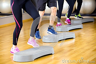 People training with step platform at fitness gym center Stock Photo