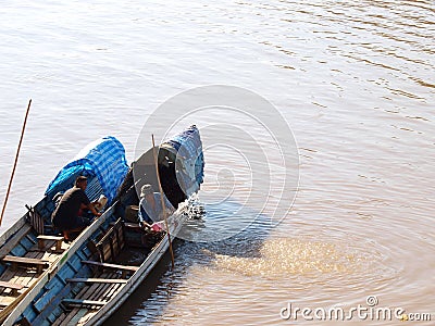 People travelling to work on normal daily lifestyle in transport boat at MEKONG river bank of LUANG PRABANG Editorial Stock Photo