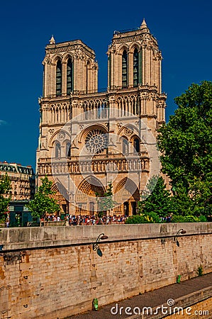 People, tree-lined Seine River and gothic Notre-Dame Cathedral at Paris. Editorial Stock Photo