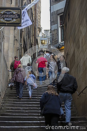 People using a close alley during the Edinburgh Fringe Festival Editorial Stock Photo